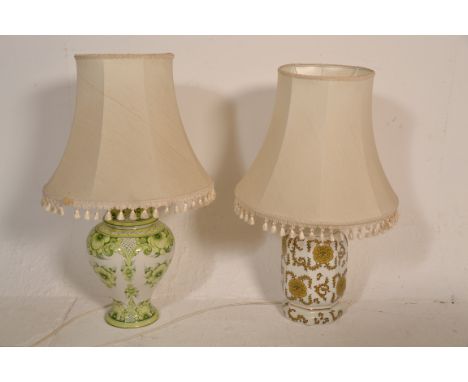 2 large 20th century ceramic table lamps of Chinese influence complete with shades. Both of ginger jar form on white grounds,