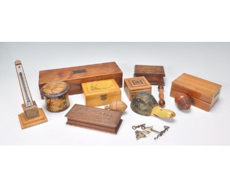 A collection of treen wares to include grater in the form of an acorn, table top boxes, painted wooden ducks head inkwell wit