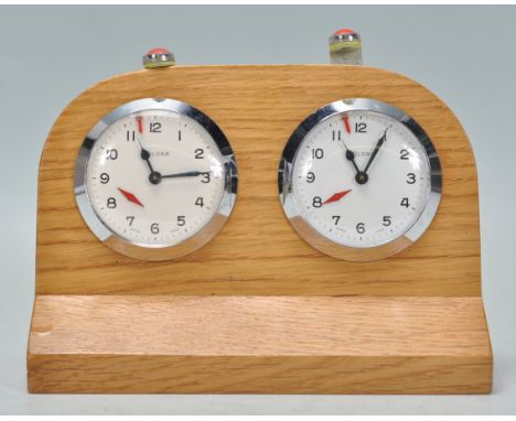 A rare vintage Solora swiss made chess clock / timer being oak cased with two clock faces having round white enamelled dials 