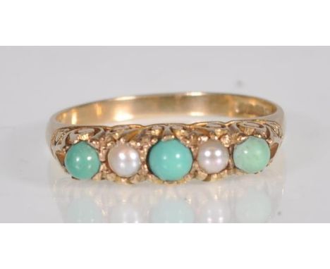 An English hallmarked 9ct yellow gold ladies dress ring set with turquoise style cabochons interspersed with faux half cut pe