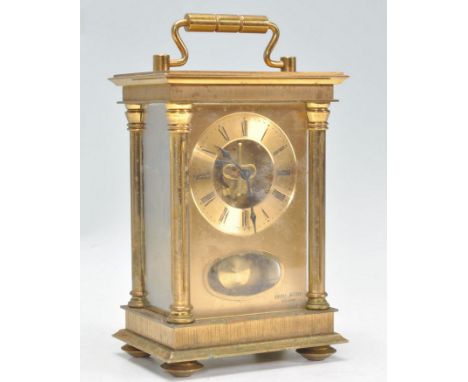 A vintage 20th Century&nbsp;8 day carriage clock being brass cased with three sides set with glazed panels. Brass face with R