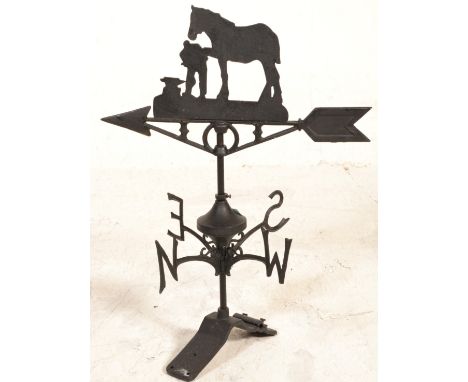 A 20th Century cast iron weather vane having North South East and West appendages with rotating arrow to top decorated with a