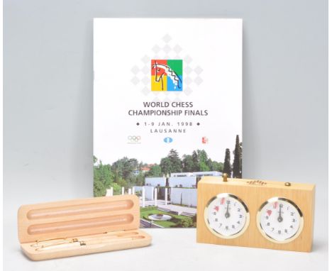 A vintage World Chess Championship finals Lausanne 1998 programme together with a branded chess championship chess clock / ti