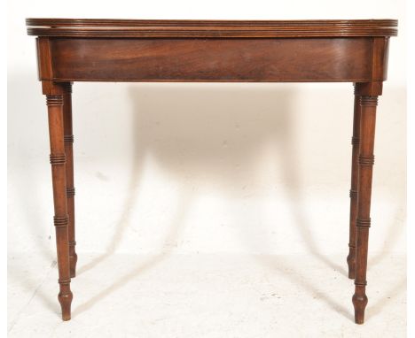 A Georgian 18th century mahogany tea / games card table being raised on ring turned faux bamboo style legs with fold over tab