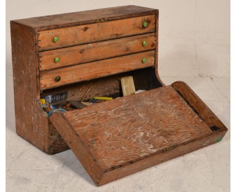 A mid 20th Century pine tool chest /&nbsp;workmans box having a half full front reveal a series of drawers within and space b