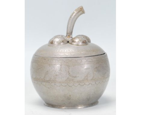 A vintage early 20th Century pewter tea caddy in the form of an apple having the stork forming the handle atop. The body havi