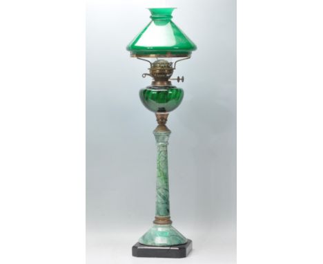 A large 20th century faux marble and green glass reservoir oil lamp with tall green faux marble column complete with green gl