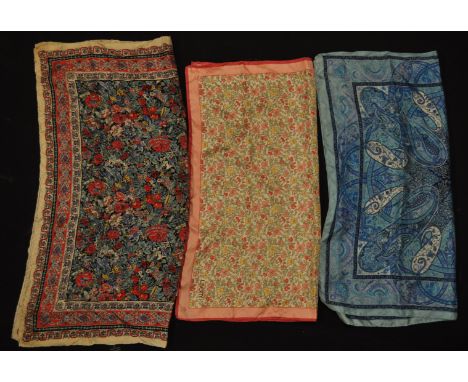 A group of three vintage Liberty printed silk scarves to include a paisley print scarf, a burgundy patterned scarf and a pink