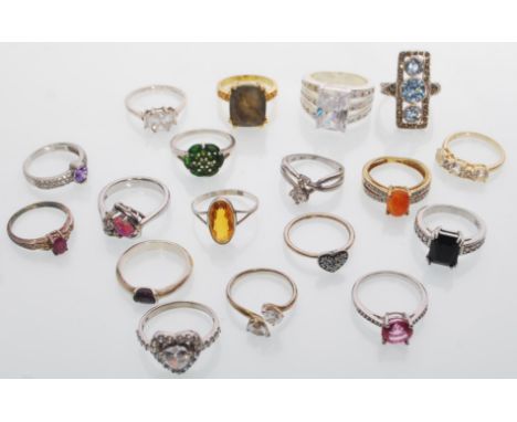 A selection of fourteen silver ladies rings to include a panel ring of square form set with blue stones, a green stone cluste