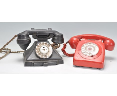 Two vintage 20th Century ring dial telephones to include a black bakelite example and a red plastic retro phone. Biggest meas