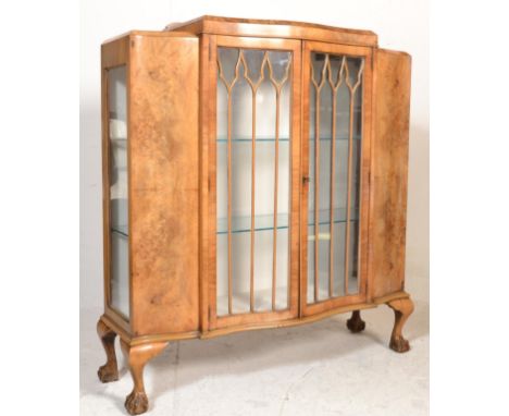 A good Queen Anne 1930's revival walnut china display cabinet vitrine being raised on claw and ball feet with stunning twin d