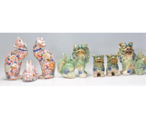 A set of four graduating Chinese fu / foo temple dogs being green and yellow / Sancai glazed together with two ceramic Imari 