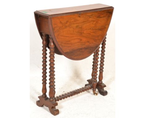 A 19th century Victorian walnut drop leaf sutherland occasional table being raised on splayed feet with bobbin turned legs ra