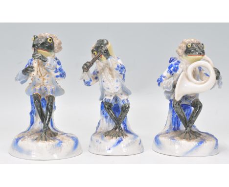 A group of three 20th Century Sitzendorf German porcelain frog band figures to include a flute player, clarinet player and a 