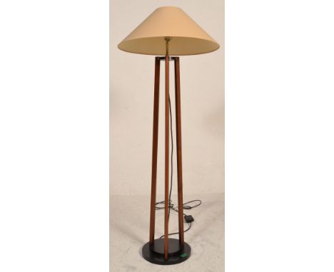 A 20th century Art Deco style mahogany and ebonised wood standard lamp. The floor standing lamp with ebonised supports comple