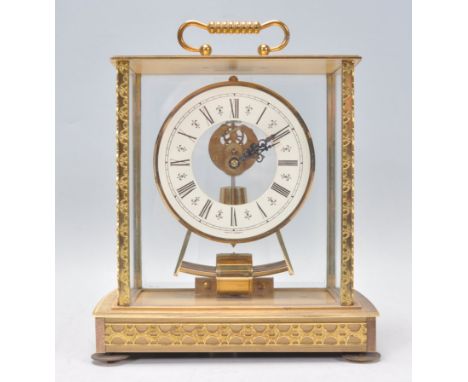 A Kieninger and Obergfell mantel clock having a brass case with glass panelled sides and an&nbsp;electromagnetic movement, wi