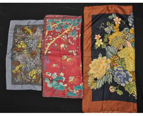 A group of three vintage Liberty printed silk scarves to include a Chinese dragon print scarf, a pink blossom print scarf and