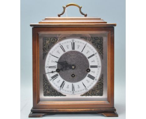 A 20th century mahogany cased bracket clock by Hermle. Roman numeral chapter ring with faceted hands, The brass movement on a