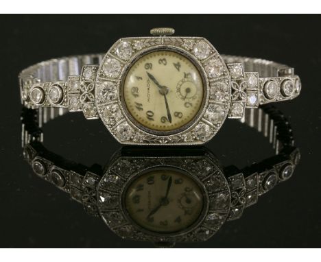 A ladies' Art Deco diamond set Movado mechanical cocktail watch, c.1930,a circular silvered dial with black Arabic numerals, 