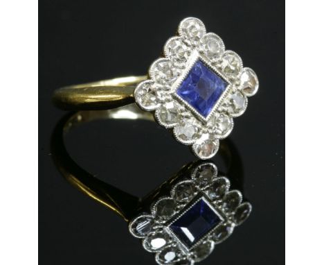 An Art Deco sapphire and diamond offset square cluster ring, c.1920,a square step cut sapphire, milligrain set to the centre,