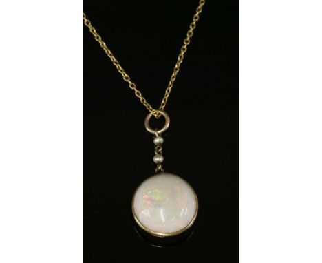 An Edwardian single stone opal pendant,with a circular tallow cut cabochon opal, spectacle set to a plain frame, suspended fr