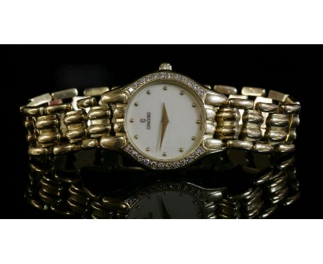 A ladies' 18ct gold diamond set Concord quartz bracelet watch,with a cream dial with gold dot batons and sword hands.  Brilli