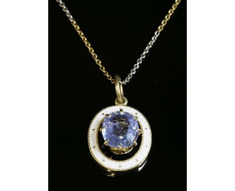 A single stone sapphire and enamel pendant, c.1915,with an oval mixed cut sapphire, estimated as approximately 3.75ct, claw s