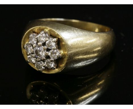 A Continental, diamond set, gold cluster ring, c.1960,with a flower head cluster of brilliant cut diamonds, claw set in white