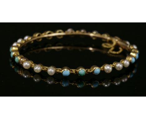 A late Victorian turquoise and split pearl hinged bangle, c.1900,a solid chain-link bangle with sets of three seed pearls and