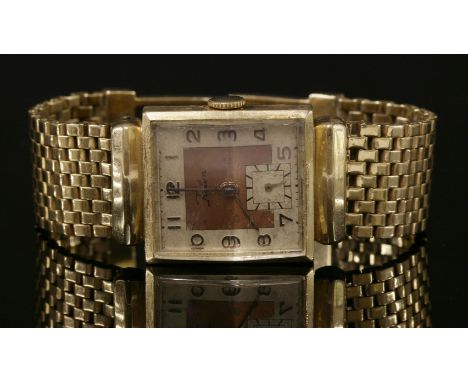 An American, gold, mechanical, Micron Watch Corp. Rulon Lapwell watch,with a later gold bracelet.  Square silvered dial with 