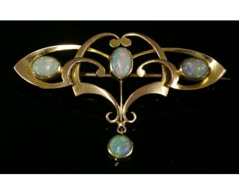 A gold, Art Nouveau, opal set bar brooch,of open whiplash form.  Scrolling tapered sections with three oval cabochon opals, r