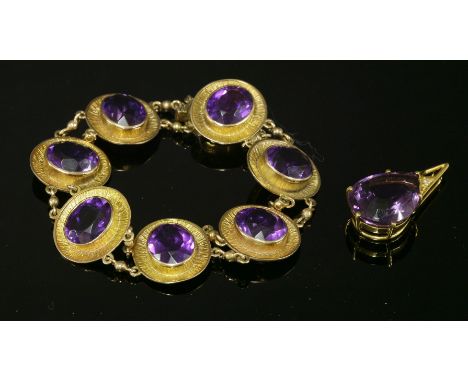 A 9ct gold amethyst bracelet, c.1960,with a series of seven, oval, mixed cut amethysts, each one rub set to a plain collet wi