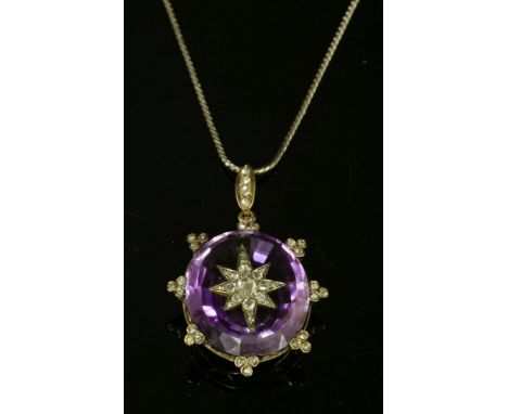 A Victorian amethyst and diamond set star pendant,with an oval Brazilian cut amethyst, claw set to a wire collet.  An applied