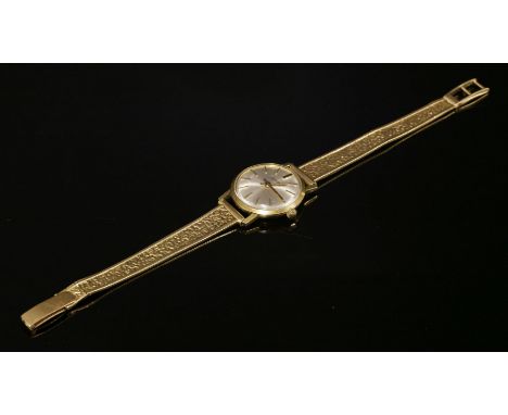 A ladies 18ct gold Eberhard mechanical strap watch, on a later gold bracelet marked 750.  Circular silvered dial with raised 
