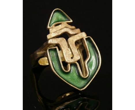 An American gold and enamel abstract ring, c.1970,by J Rossi, recessed sections with green enamel decoration to each end, wit