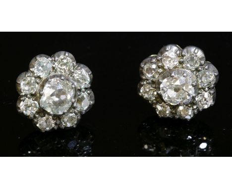 A pair of Victorian diamond cluster earrings, with a later solid basket, post and butterfly fittings.  A cushion cut diamond,