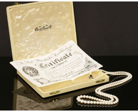 A single row graduated opera length cultured pearl necklace, with an amethyst and diamond clasp.  One hundred and fifty-four 
