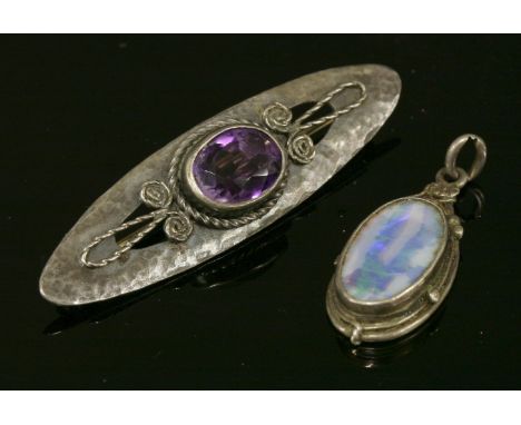 An Arts and Crafts, silver and gold, black opal pendant,attributed to Rhoda Wager, an oval cabochon black opal, rub set to a 