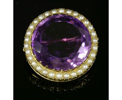 A former Austro-Hungarian Empire amethyst and split pearl brooch, c.1900.  A circular mixed cut amethyst, claw set and surrou