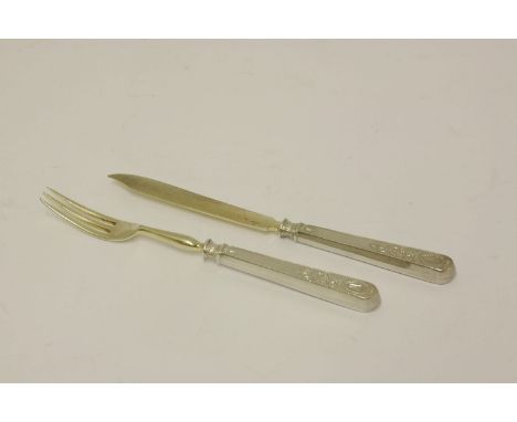 A Russian silver knife and fork,Fabergé, c.1890,the handles chased with garlands and the blades struck 'KF' and 'K Fabergé' i