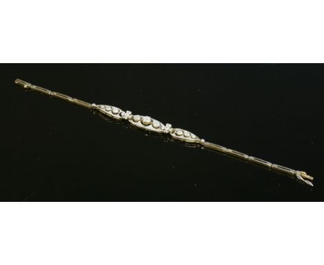 A French Belle Époque diamond set bracelet, c.1915,with a centrepiece of three articulated plaques.  A central oval plaque wi