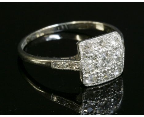 An Art Deco diamond set square cluster ring, with nine graduated old European and old Swiss cut diamonds, milligrain set to a