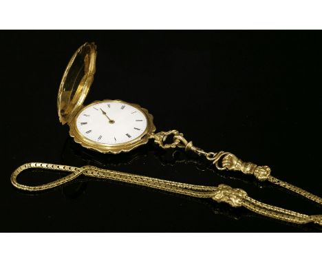 A French gold hunter fob watch,suspended on a gold guard chain with a slide.  A scroll edge case with hand engraved rococo-st