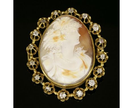 A late Victorian diamond set shell cameo brooch,depicting the profile of a lady in a light cream and tan, to a tan ground.  T