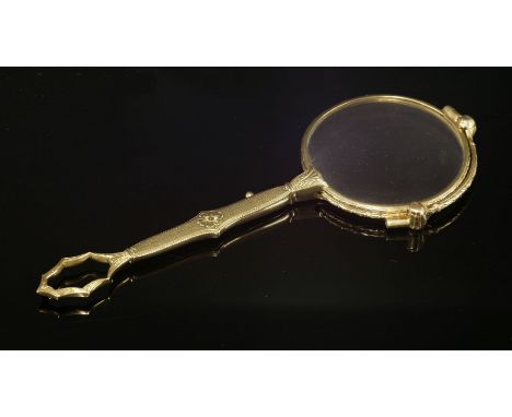 A pair of gold lorgnettes, c.1915,with hand engraved laurel leaf frames.  Spring action handle with engine turned decoration 