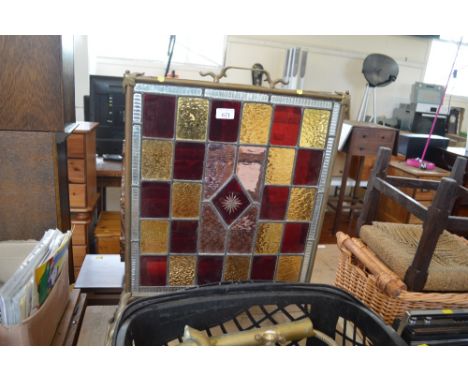 A brass and stained glass fire screen 
