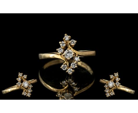 14ct Gold Diamond Set Dress Ring, set with a central round cut diamond and eight further diamonds.  Stamped 14k.  Ring size O