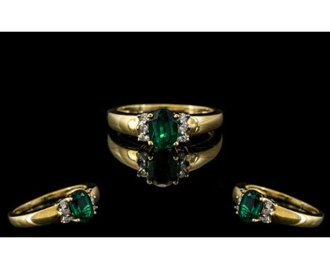 9ct Gold Diamond &amp; Green Stone Dress Ring, oval cut green faceted stone set between brilliant cut diamonds.  Fully hallma