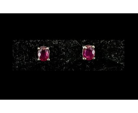 Ruby Solitaire Stud Earrings, single, oval cut rubies, of rich red and petite size, set in platinum vermeil and silver post a