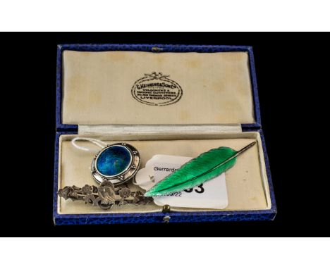 Two Enamel Brooches, to include a green enamel leaf brooch and a Ruskin round brooch together with a small silver sweetheart 